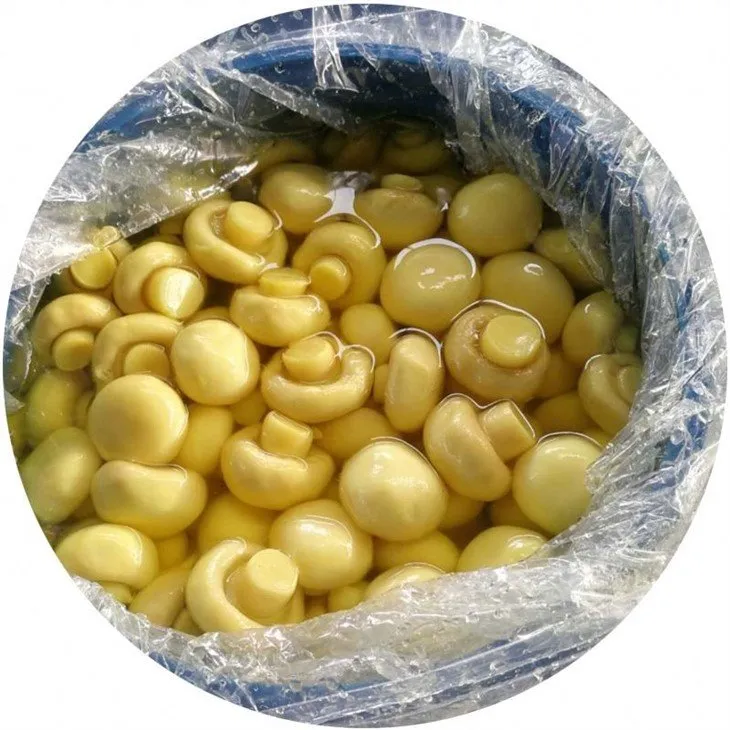 Whole champignon mushroom in brine in barrel